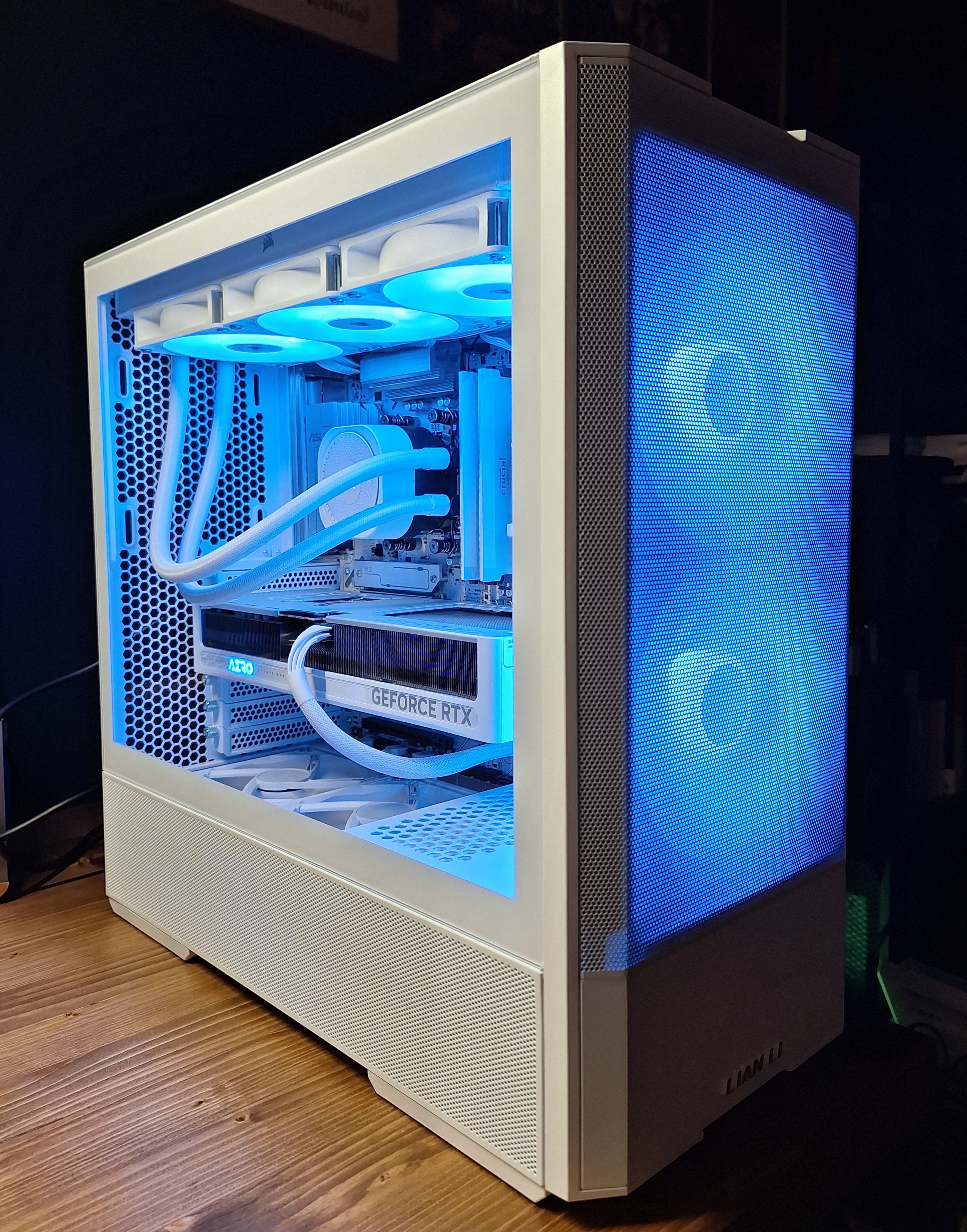 Front three-quarter view of the white Lancool 207 with blue-lit intake fans and interior